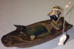 Ceramic Figurine-Fisherman On A Boat Fishing With Duck
