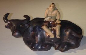 Ceramic Figure-Man Sitting On Sitting Buffalo-Large