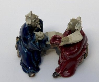 Ceramic Figurine-Two Men Sitting On A Bench Holding Fan & Pipe- 2.0-Color: Red & Blue