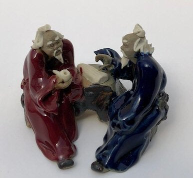 Ceramic Figurine-Two Men Sitting On A Bench Holding a Pipe- 2.25-Color: Blue & Red