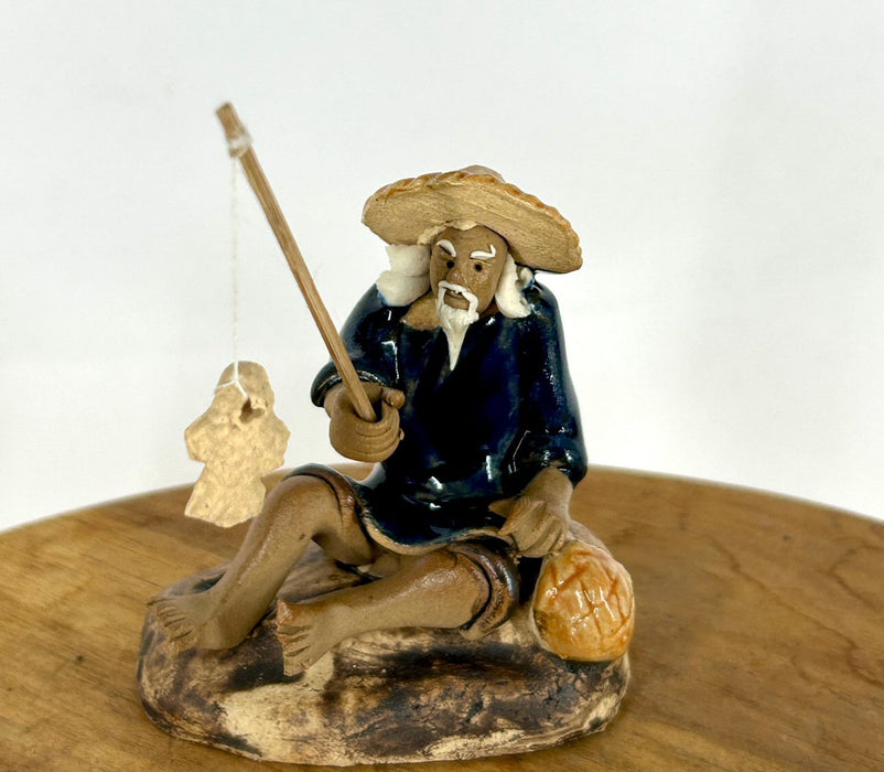 Miniature Ceramic Glazed Fisherman Figurine-Sitting On A Log -Blue - 2.5