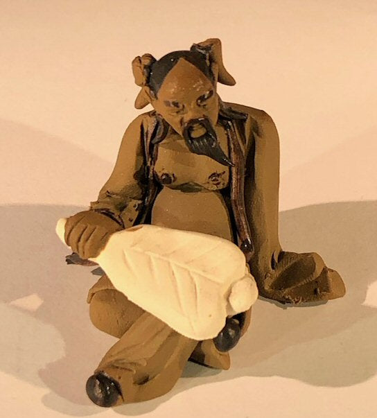 Ceramic Figurine- Mud Man Holding a Fan Sitting Down - 2-